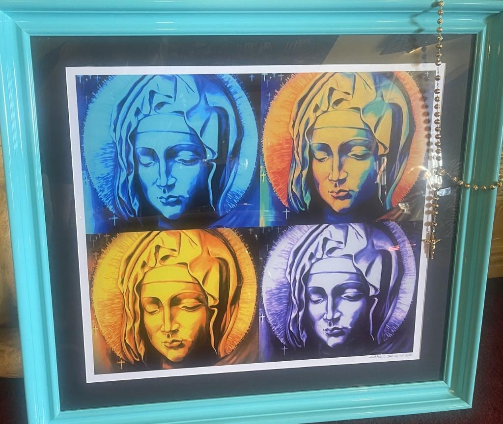 Framed pop-art style print of four colorful Madonna portraits in teal frame